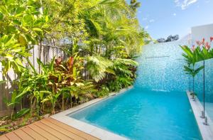 a swimming pool in the middle of a house with trees at Noosa Villas in Noosaville