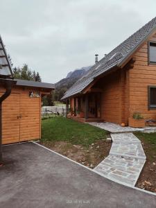 a house with a garage next to a building at Apartment Jeršin in Rateče