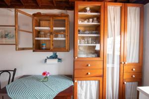 a kitchen with a table and a wooden cabinet at La Ventana del Bentayga in Tejeda