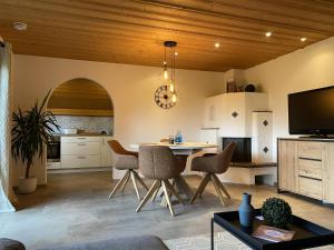 a kitchen with a table and chairs in a room at Gästehaus Walter in Eisenberg