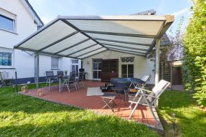 awning over a patio with chairs and a table at Entspannung Pur in Herford