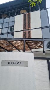 a building with a college sign in front of it at Colive Ahangama in Ahangama
