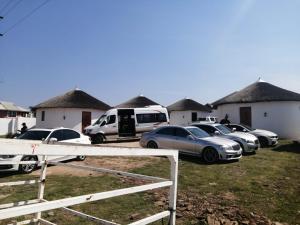 a group of cars parked in front of some houses at Nogixa Lodge in Umzimkulu
