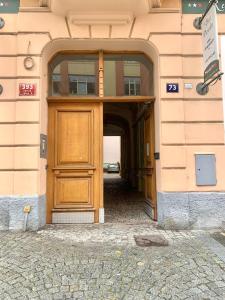 a door leading to a large room with a large window at Casa Italia in Prague