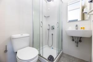 a bathroom with a shower and a toilet and a sink at Hippocampus Hotel in Naousa