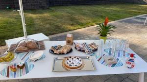 a white table with bread and other food on it at Naturamare B&B in Villapiana