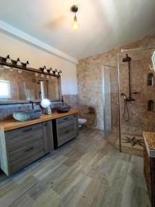 a large bathroom with a shower and a sink at Villa Carioca - with private pool, marvelous garden and amazing ocean view in Sauzal