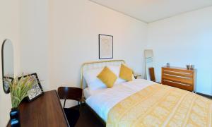 a bedroom with a bed and a table and a desk at Brand-New, Close to Centre, Rooftop-Summer-Pool in Vienna