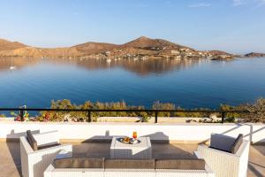 a view of a lake with two chairs and a table at Hippocampus Hotel in Naousa