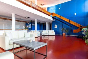 a living room with white furniture and a blue wall at Hippocampus Hotel in Naousa