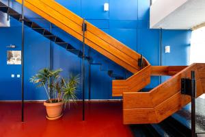 una escalera de madera en una pared azul con plantas en Hippocampus Hotel en Naousa