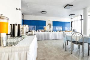 a kitchen with blue walls and a table and chairs at Hippocampus Hotel in Naousa