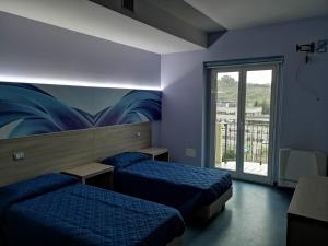 A bed or beds in a room at Hotel Clodi