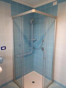 a shower with a glass enclosure in a bathroom at Hotel Clodi in Ascoli Piceno