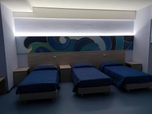 A bed or beds in a room at Hotel Clodi