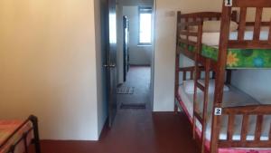 a hallway with two bunk beds in a room at Cocoa Mews Cafe and Homestay in George Town