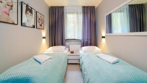 Łóżko lub łóżka w pokoju w obiekcie Wonder Home - Apartamenty położone blisko deptaka, licznych restauracji i sklepów