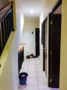 a hallway with a staircase and a floor with a basket at Aloha Guest House 2 - Female Only in Tangerang +26 photos