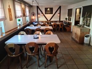 a restaurant with tables and chairs in a room at Gasthof Wolfs Stuben in Reichenbach an der Fils
