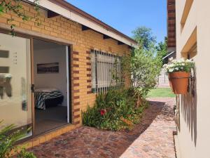 a brick house with a sliding glass door at Catch your Breath in Edenvale