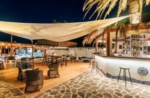 a restaurant with a bar with tables and chairs at Giardino Eden Resort in Ischia Town