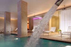 a pool of water in a swimming pool at Palazzo Montemartini Rome, A Radisson Collection Hotel in Rome