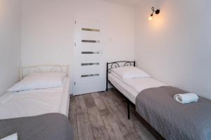Posteľ alebo postele v izbe v ubytovaní Apartament Nero