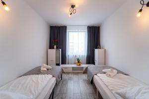 Posteľ alebo postele v izbe v ubytovaní Apartament Nero
