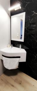 a bathroom with a white sink and a mirror at SOKÓŁ in Sobków