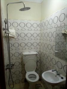 a bathroom with a toilet and a sink at Dich Comfort Hotel University Branch in Gulu