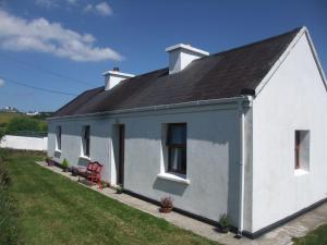a white house with a black roof at Katie's Cottage in Achill Sound