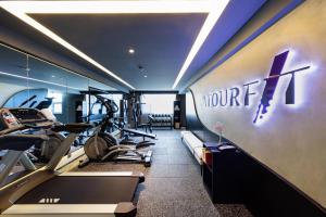 a gym with cardio equipment in a hotel room at Atour Hotel Heze Ancient City Park in Heze