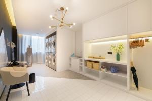 a living room with a white floor and a ceiling at Atour Hotel Ningbo Fenghua Huizheng Street in Ningbo