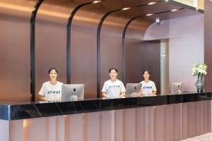 a group of people standing in front of a mirror at Atour Hotel Guilin Yangshuo West Street in Yangshuo