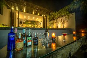 
a bar with a lot of bottles on it at Three Gables Boutique Villa in Mirissa
