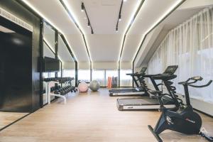 a gym with treadmills and elliptical machines at Atour Light Nanjing Xinjiekou NetEase CloudMusic in Nanjing