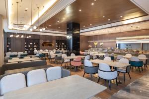 a restaurant with tables and chairs and a bar at Atour Hotel Guilin Yangshuo West Street in Yangshuo