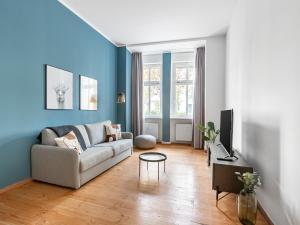 a living room filled with furniture and a window at limehome Berlin Malmöer Straße in Berlin