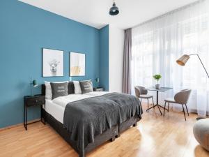 a bedroom with a large bed and a large window at limehome Berlin Malmöer Straße in Berlin