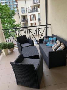 a balcony with chairs and couches on a building at Baltic Park Apartament in Świnoujście