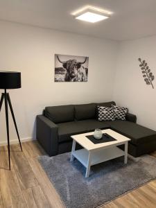 a living room with a couch and a table at Ferienwohnung Familie Heite in Olpe