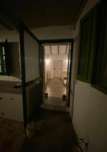 an empty room with a hallway leading to a kitchen at Nos Kasa Povoaçao Velha in Cabeçadas