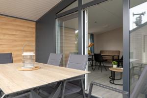 a dining room with a table and chairs at Chalet bis sechs Personen ohne Hund - a61179 in Norden