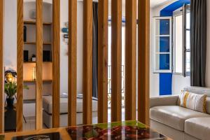 a living room with a couch and a table at Casa Nostra : bienvenue chez nous ! in Saint-Florent +2 photos