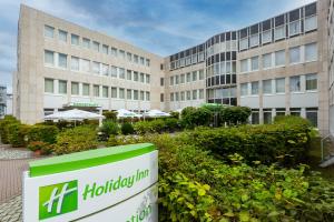 an office building with a huawei sign in front of it at Holiday Inn Frankfurt Airport - Neu-Isenburg by IHG in Neu Isenburg