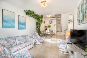 a living room with a couch and a table at Big Villa Sagaró in S'Agaro