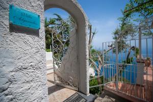 a gate to a villa with a view of the ocean at Villa Algarrobos in Praiano