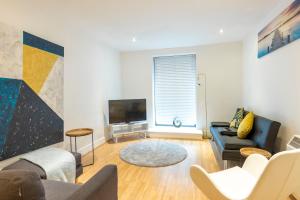 a living room with a couch and a tv at Leicester Luxury Apartments - Eastgate in Leicester