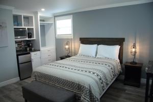 a bedroom with a large bed and a window at CARLETON INN & COTTAGES in Bridgetown