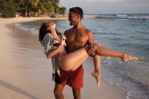 a man and a woman standing on the beach at Sugar Bay Barbados - All Inclusive in Bridgetown